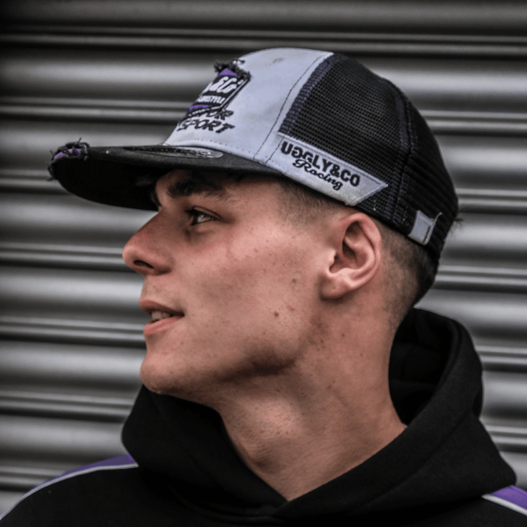 Purple diamond trucker cap by Uggly and Co featuring JDM Racing branding, with mesh back and adjustable snap closure.
