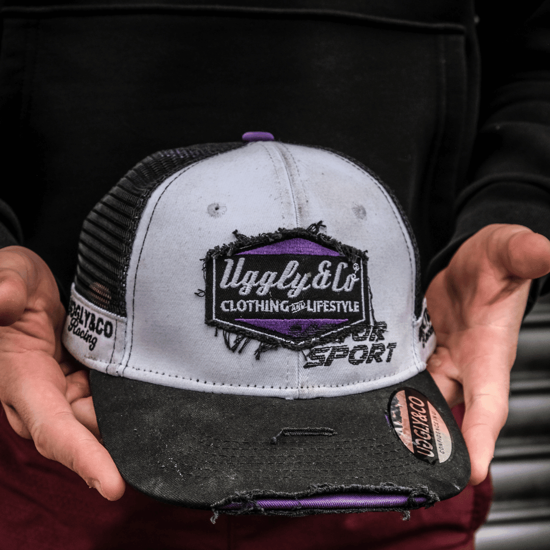 Purple diamond trucker hat by Uggly and Co featuring JDM Racing branding, with mesh back and curved brim.