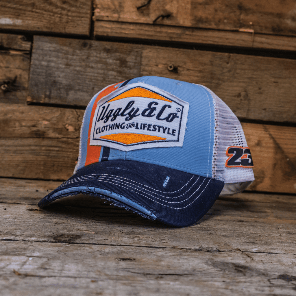 Retro blue and orange diamond trucker cap by Uggly and Co featuring mesh back and adjustable strap.
