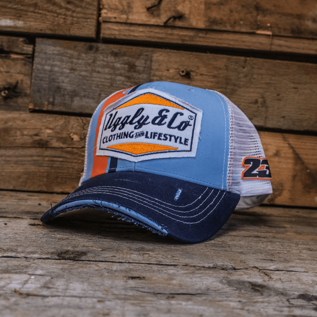 Retro blue and orange diamond trucker cap by Uggly and Co featuring mesh back and adjustable strap.
