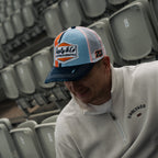 Retro blue and orange diamond pattern trucker cap by Uggly and Co, featuring a classic trucker hat design with mesh back.