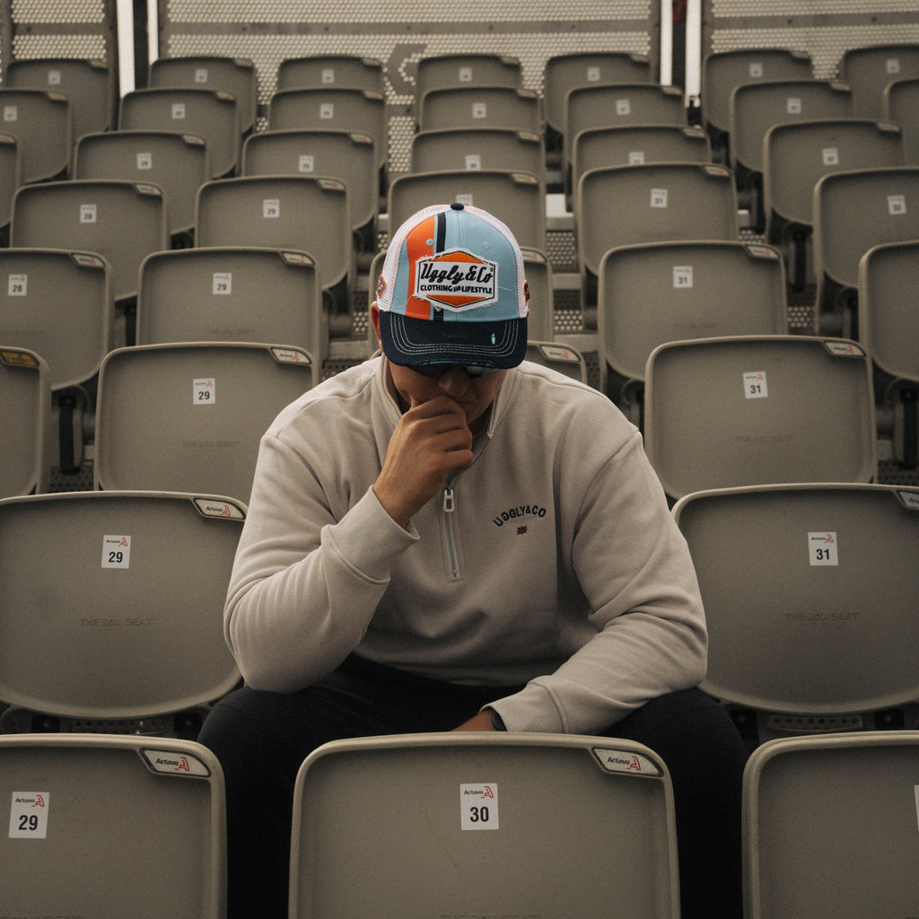Retro blue and orange diamond pattern trucker cap by Uggly and Co featuring mesh back and adjustable snap closure.