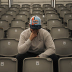 Retro blue and orange diamond pattern trucker cap by Uggly and Co featuring mesh back and adjustable snap closure.