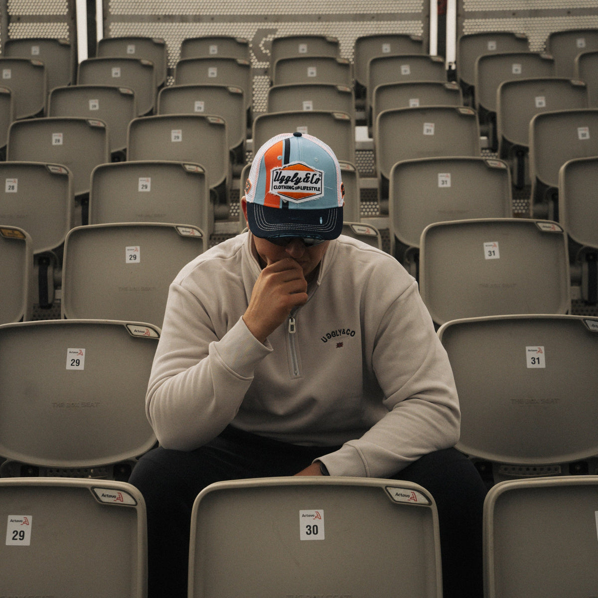 Retro blue and orange diamond pattern trucker cap by Uggly and Co featuring mesh back and adjustable snap closure.