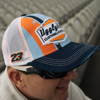Uggly and Co retro blue and orange diamond patterned trucker cap featuring a classic mesh back and curved brim.