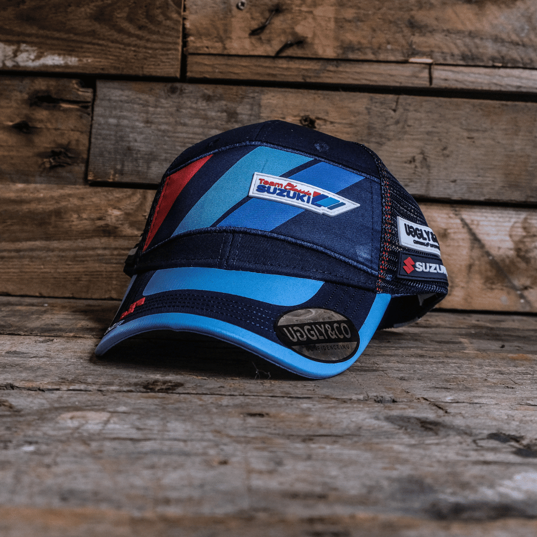 Uggly and Co Team Classic Suzuki trucker hat with adjustable snapback, featuring embroidered Suzuki logo on front.