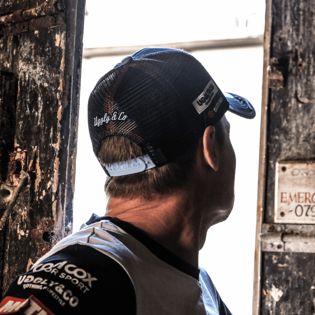 Uggly and Co Team Classic Suzuki Trucker Hat featuring a mesh back and embroidered Suzuki logo on the front.