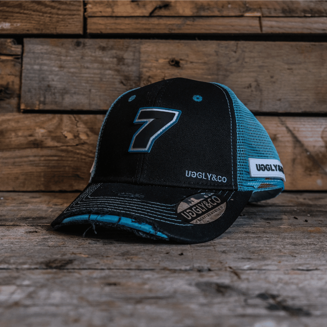 Black and blue Uggly and Co Davey Todd merchandise trucker hat with adjustable strap and embroidered logo.