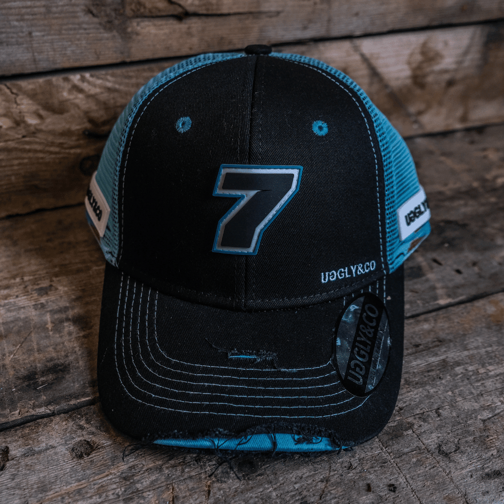 Black and blue Uggly and Co trucker cap featuring official Davey Todd merchandise, with a structured crown and curved brim.