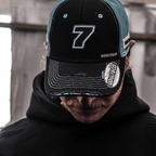Black and blue Uggly and Co Trucker Cap featuring official Davey Todd merchandise, with a classic trucker hat design.