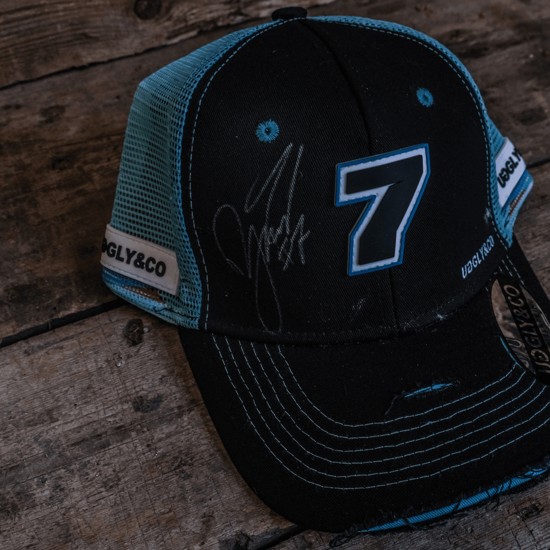 Black and blue Uggly and Co Davey Todd merchandise trucker hat with mesh back and adjustable strap.