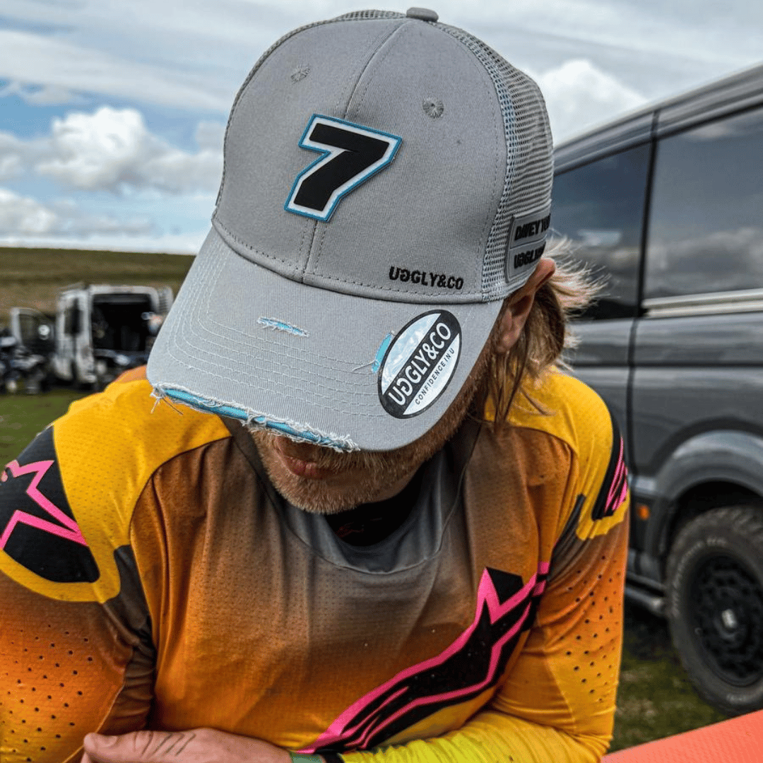Steel grey Uggly and Co Trucker Cap featuring official Davey Todd merchandise, with a classic mesh back and curved brim.