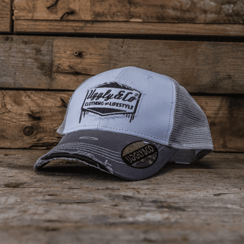 Grey and white diamond pattern Uggly and Co trucker cap, featuring a classic trucker hat design with stylish diamond details.