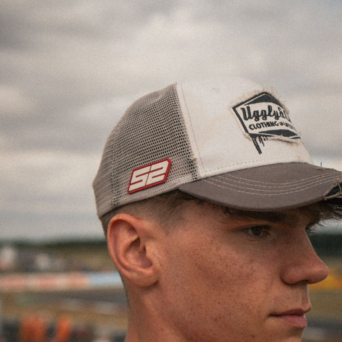 Grey and white diamond trucker cap by Uggly and Co featuring a classic design and adjustable mesh back.