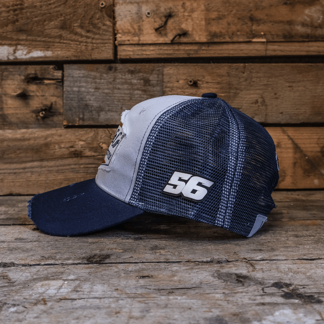 Navy blue and white diamond pattern trucker cap by Uggly and Co, featuring mesh back and curved brim for casual style.