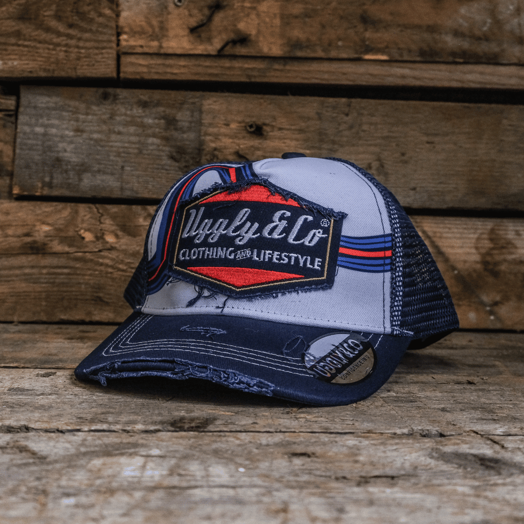 Retro blue and red diamond trucker cap by Uggly and Co featuring mesh panels and adjustable snapback closure.