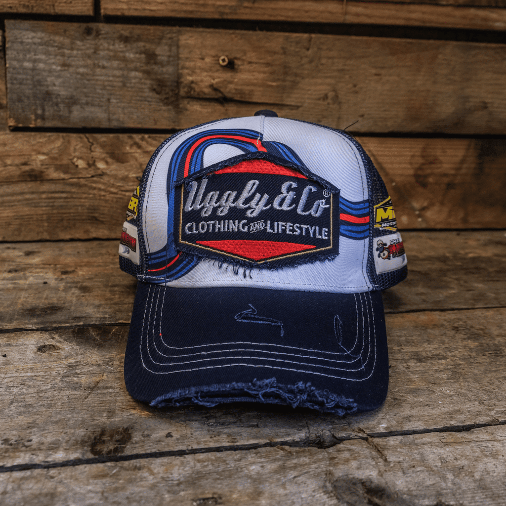 Uggly and Co retro blue and red diamond trucker cap, adjustable mesh trucker hat with bold geometric pattern and curved brim.