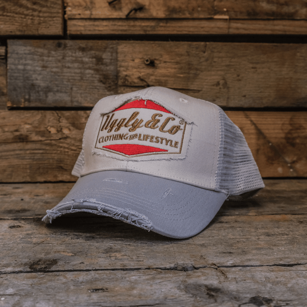 Silver and grey diamond-patterned Uggly and Co trucker cap with mesh back, featuring a stylish motorcycle-themed design.