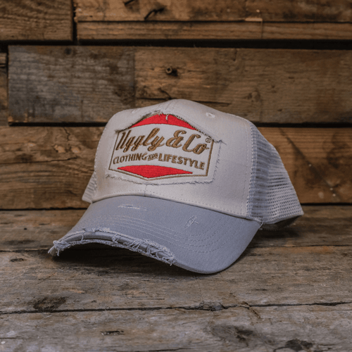 Silver and grey diamond trucker cap by Uggly and Co featuring a classic mesh back and structured front with diamond detailing.