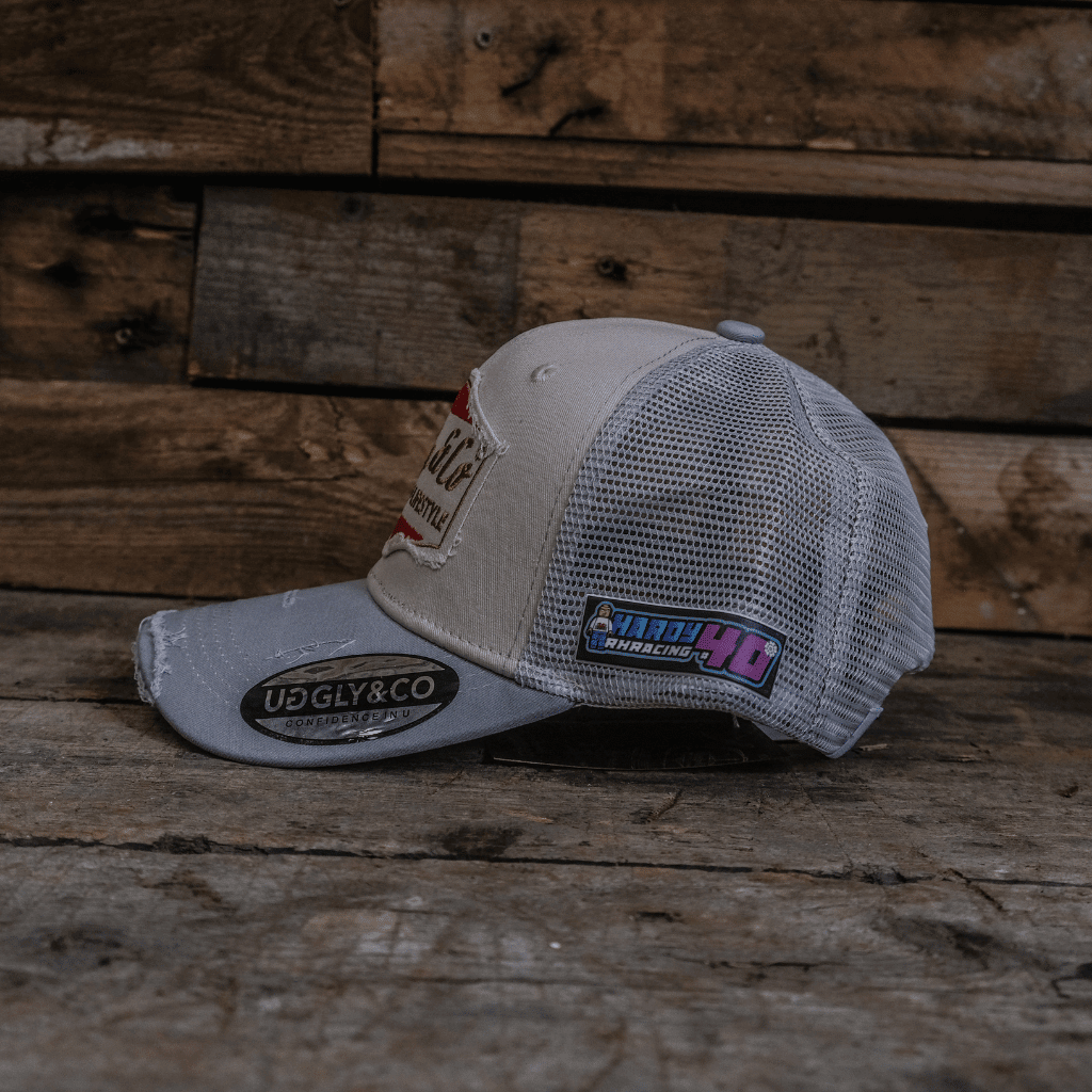 Silver and grey diamond-patterned trucker cap by Uggly and Co featuring a classic mesh back and adjustable strap.