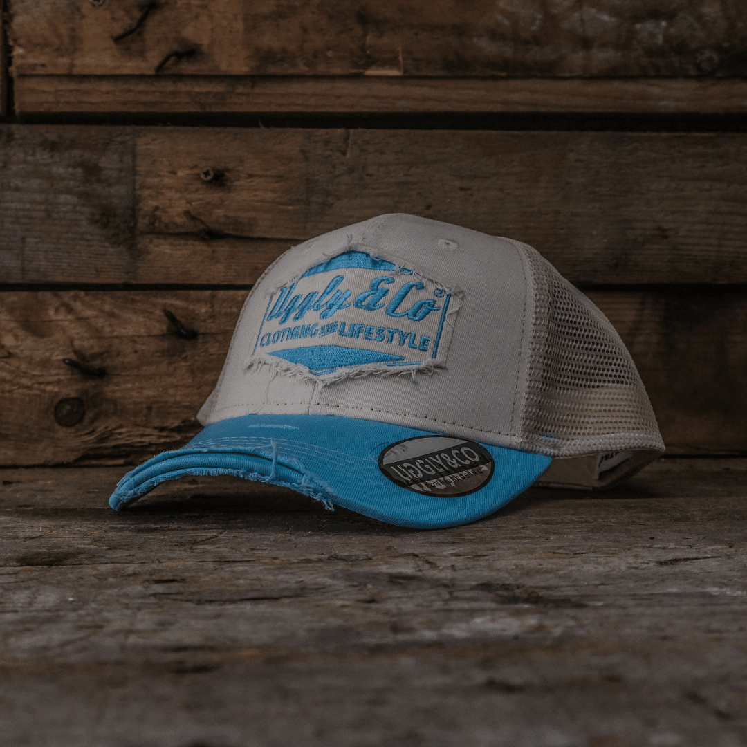 Sky blue and white diamond-patterned trucker cap by Uggly and Co featuring a classic mesh back and curved brim.