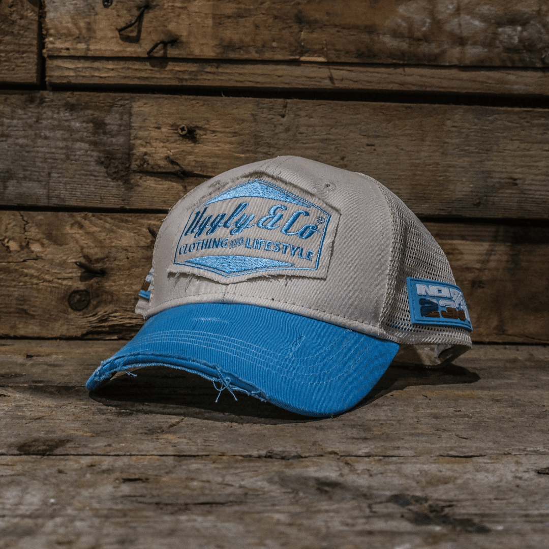 Sky blue and white diamond pattern trucker cap by Uggly and Co featuring mesh back and adjustable strap.