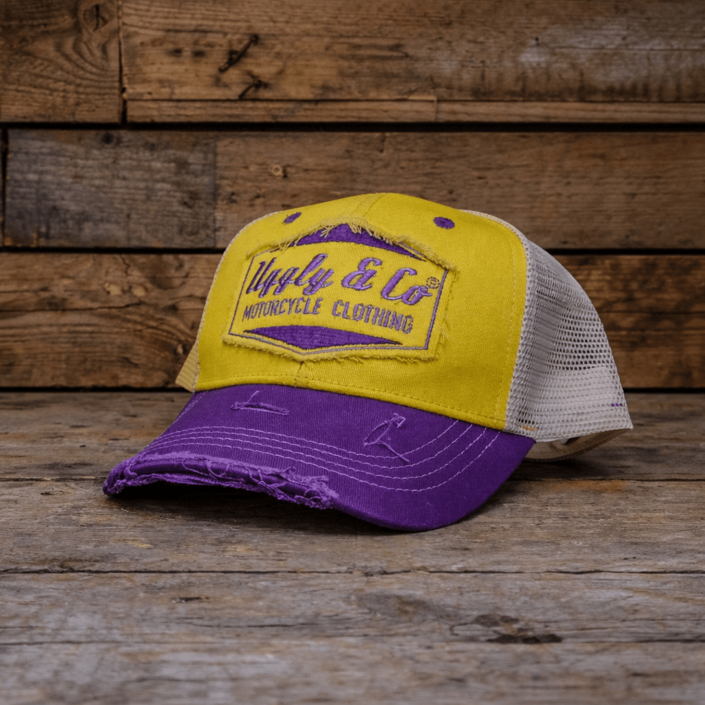 Yellow and purple diamond trucker cap by Uggly and Co featuring a stylish design and adjustable mesh back.