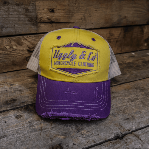 Yellow and purple diamond-patterned trucker cap by Uggly and Co featuring a classic mesh back and adjustable strap.