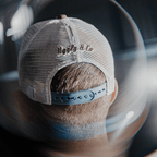 Dusty blue flat track trucker cap by Uggly and Co featuring a classic mesh back and adjustable snap closure.