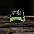 Yellow and white diamond-patterned Uggly and Co trucker cap with mesh back and curved brim.