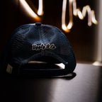 Navy blue and white diamond trucker cap by Uggly and Co with mesh back and logo on front panel.