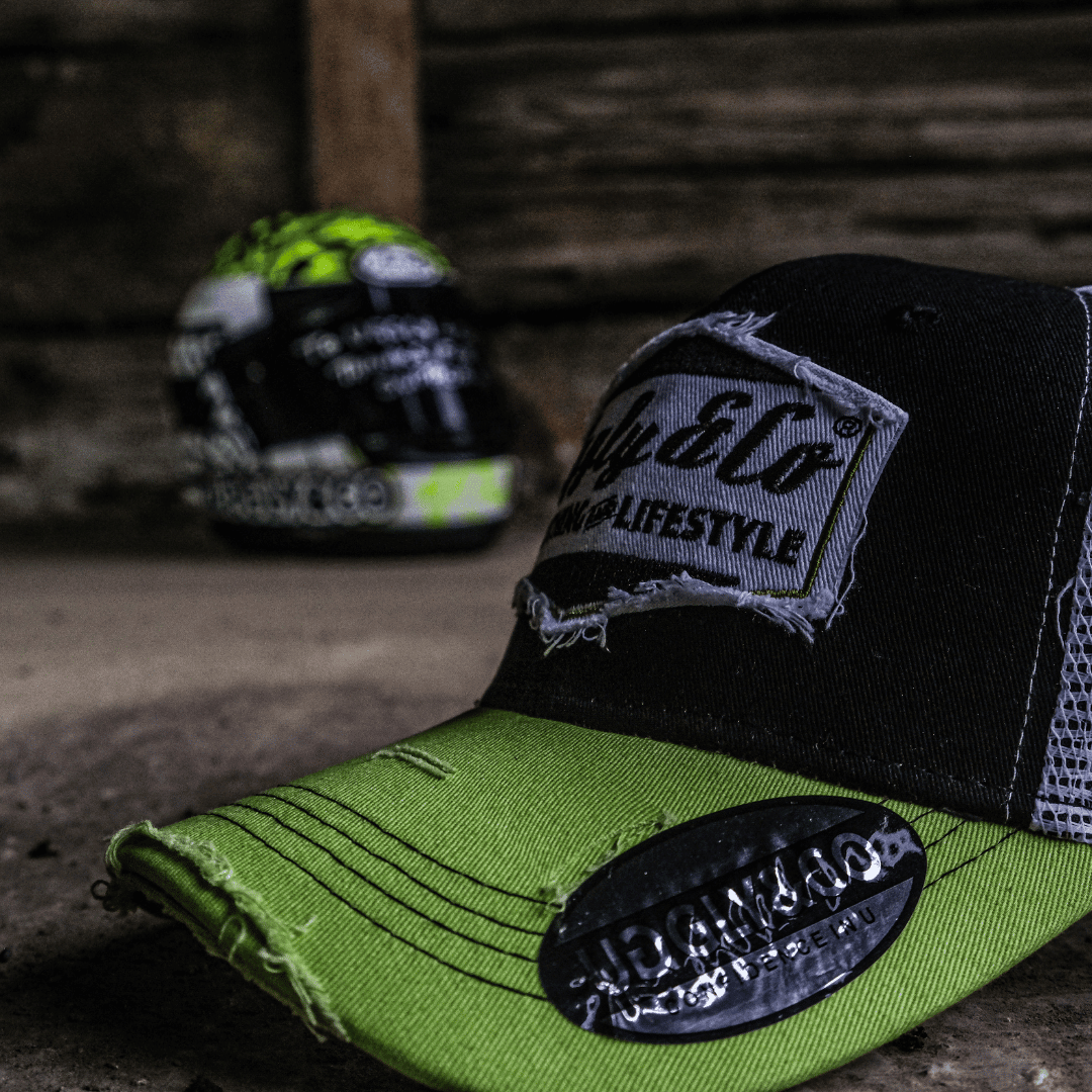 Yellow and white diamond-patterned Uggly and Co trucker cap with mesh back and curved brim.