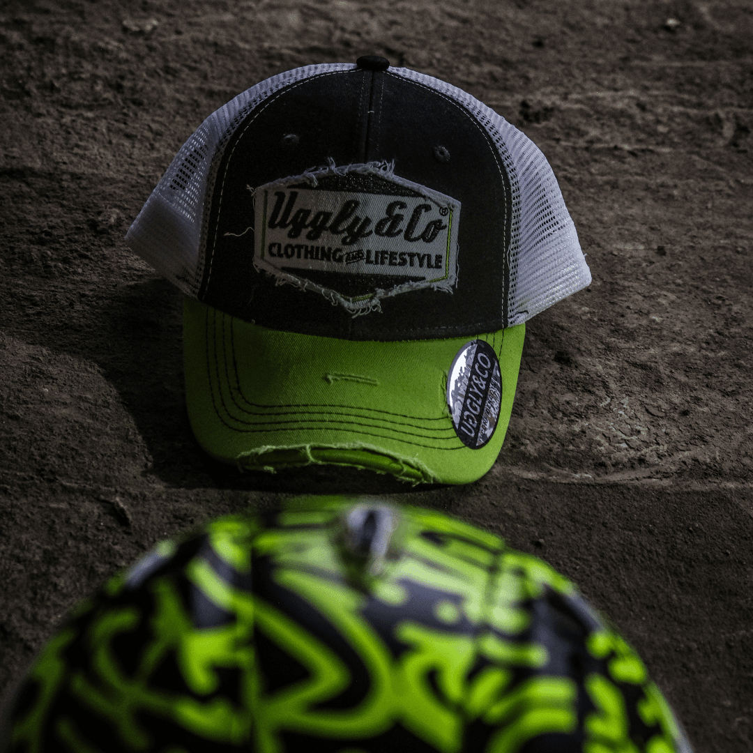 Yellow and white diamond-patterned Uggly and Co trucker cap with mesh back and curved brim, casual fashion accessory.