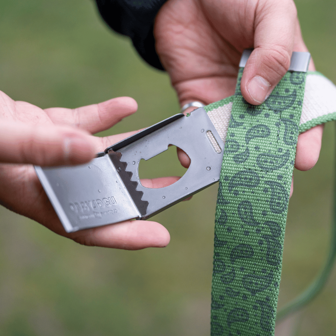 Green canvas utility belt by Uggly and Co with multiple pouches, designed for practical everyday accessories and outdoor use.