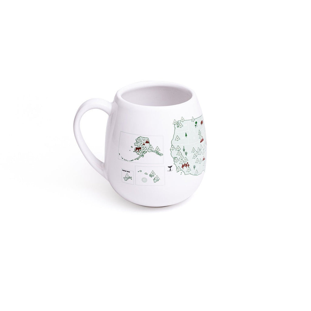 Trouvaille US National Parks color-in mug featuring detailed park illustrations and a white ceramic surface for coloring.