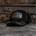 Black and gold Uggly and Co 'Podium' diamond trucker cap with heritage-style design, featuring a structured front and mesh back.