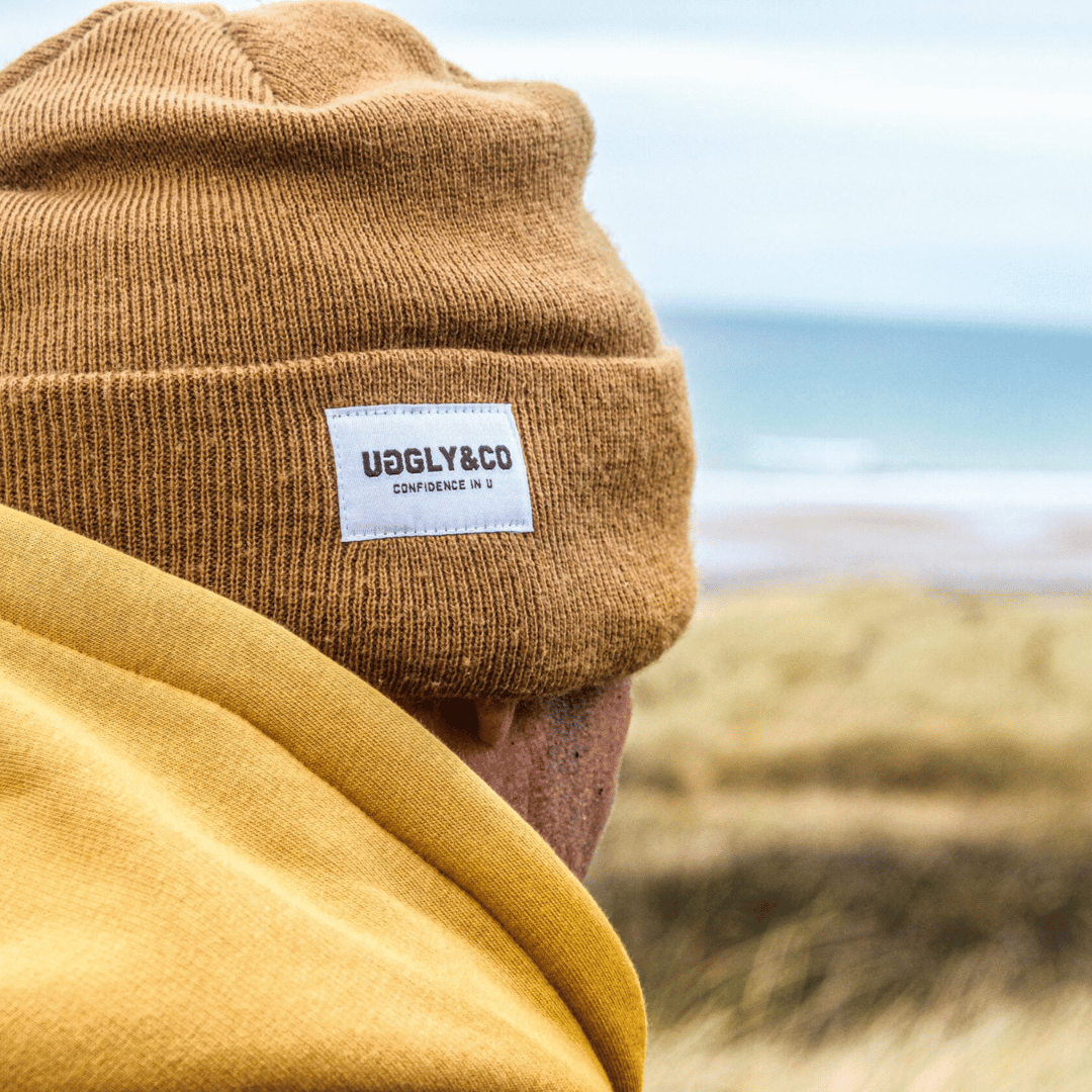 Uggly and Co mustard beanie with a cozy knit texture, stylish and warm for winter wear.
