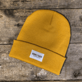 Yellow Uggly and Co beanie hat with a cozy, knitted texture, perfect for casual winter wear.