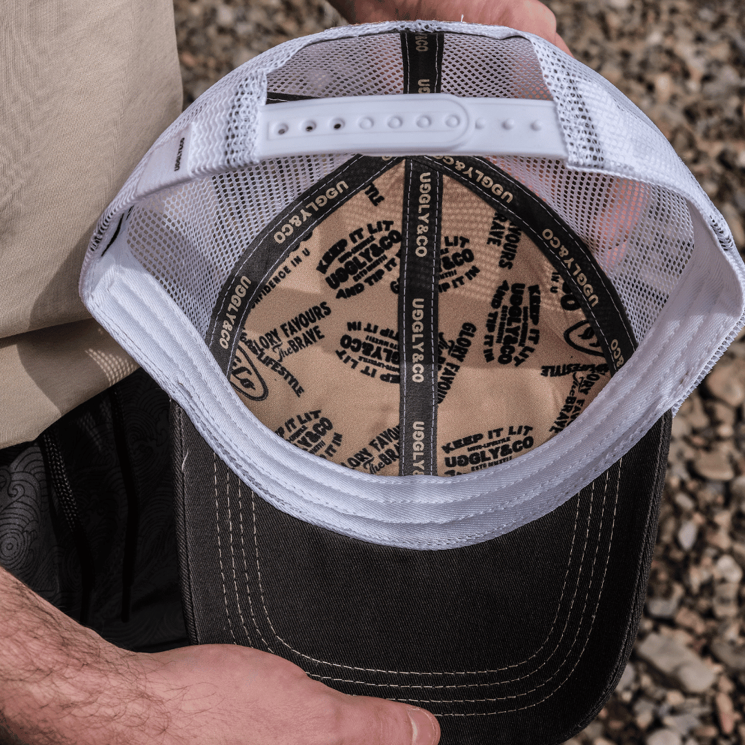 Weathered beige surf diamond trucker hat by Uggly and Co with a classic mesh back and curved brim.